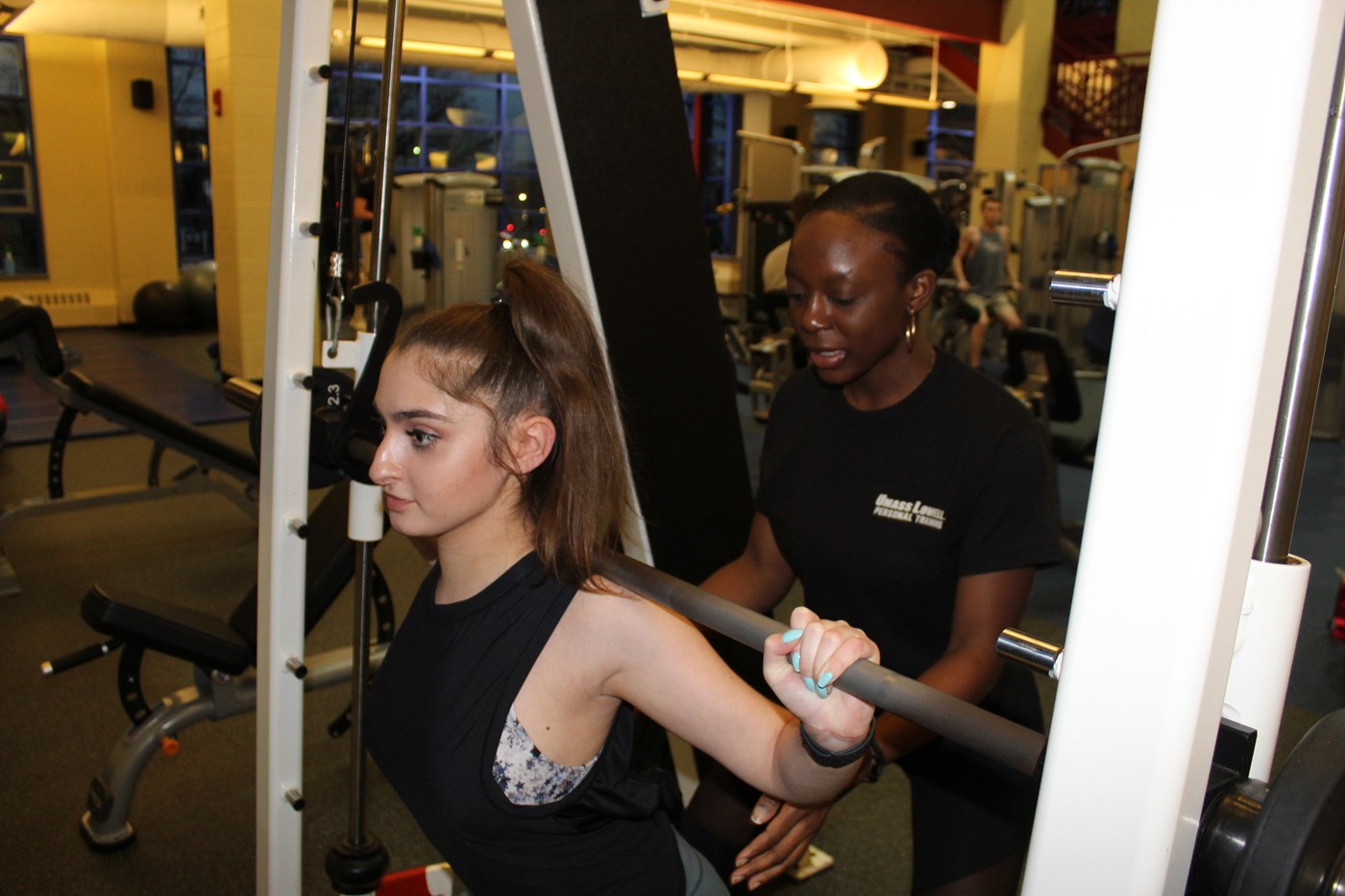 Personal Trainer spotting student client on Smith Machine in CRC Fitness Center